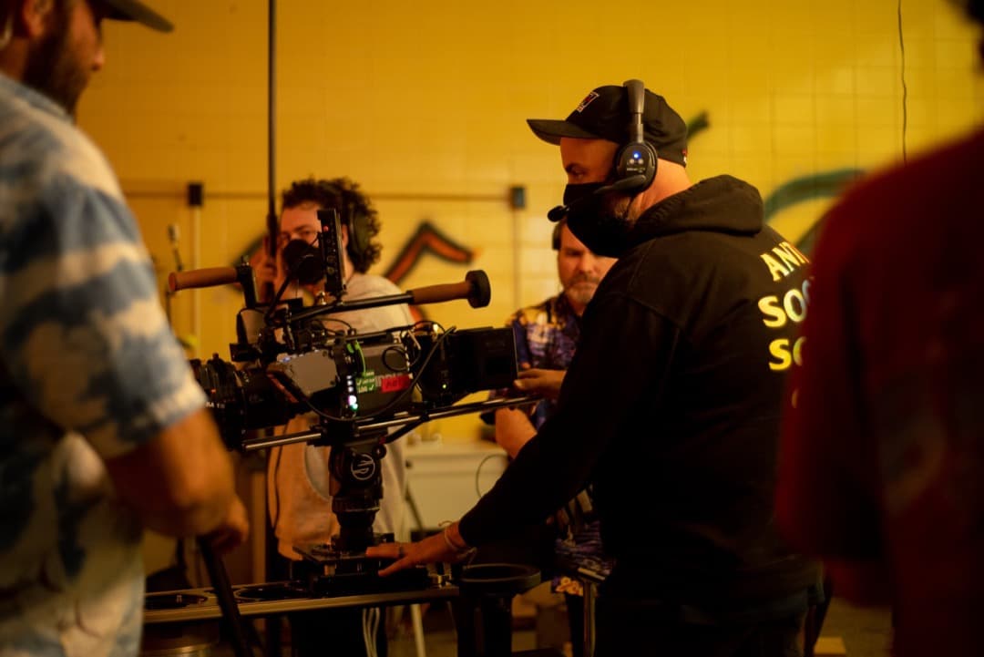 Behind the scenes photo 18 from Clone Cops production showing cinematographer corey allen, gaffer barrett dennison, and boom operator jared grimes preparing for a scene